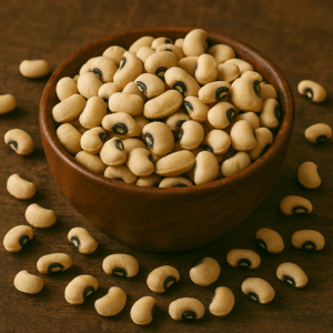 A wooden bowl filled with Lobia (black-eyed peas) placed on a rustic wooden background, with beans scattered around for a natural and organic look.