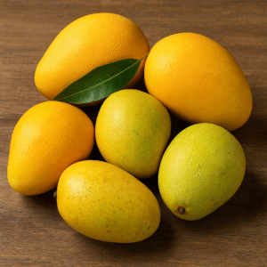 A mix of ripe Alphonso and Kesar mangoes placed on a wooden surface, showcasing their vibrant yellow and golden hues, ideal for premium fruit export.